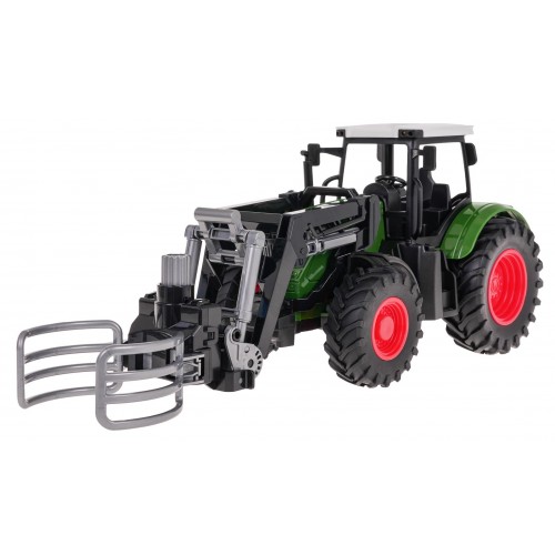 Zelený traktor s drapákem