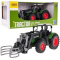 Zelený traktor s drapákem