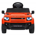 Oranžové vozidlo Land Rover Defender