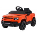 Oranžové vozidlo Land Rover Defender