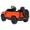 Oranžové vozidlo Land Rover Defender