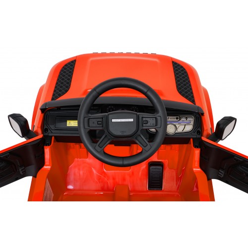 Oranžové vozidlo Land Rover Defender